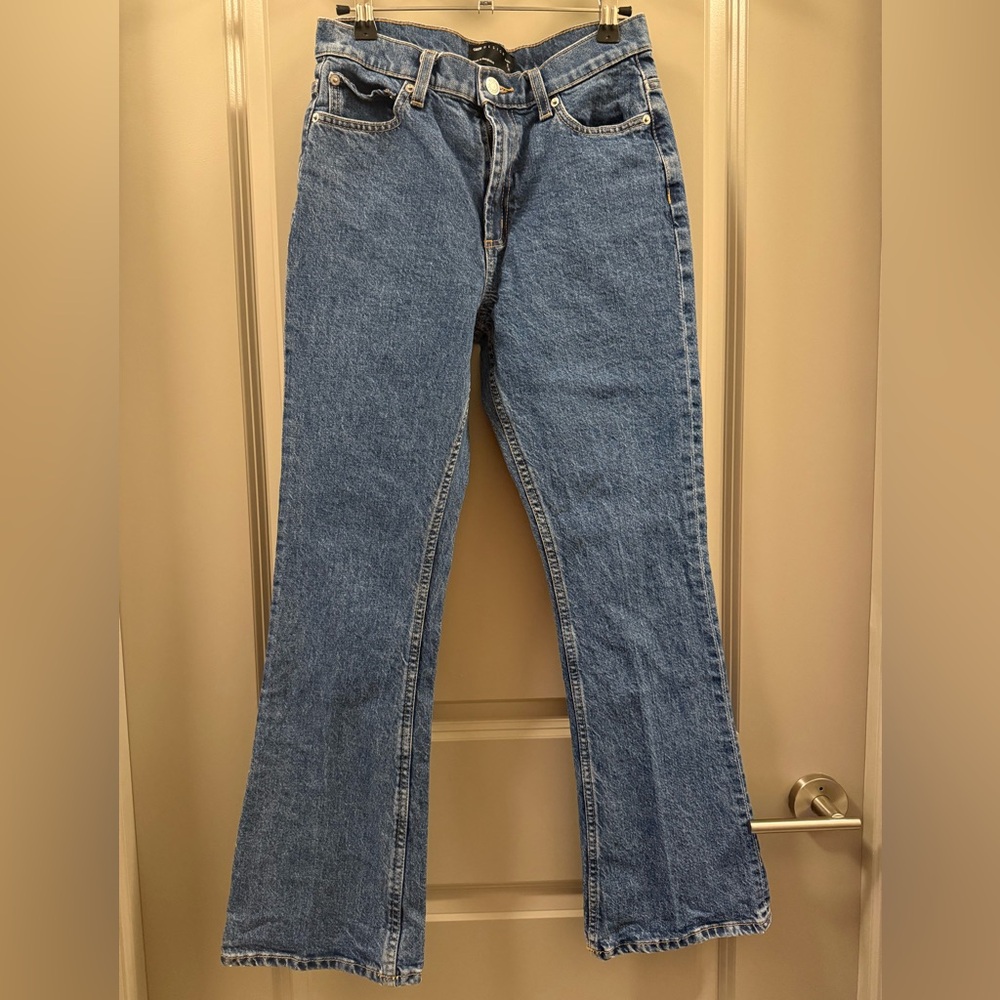 ASOS DESIGN Petite mid rise flare jeans in mid blue